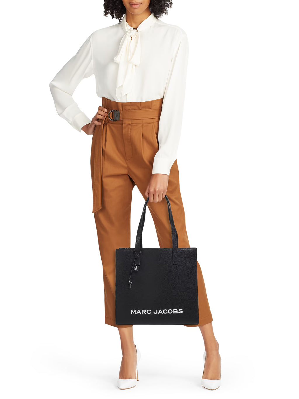 Marc Jacobs Grind leather tote bag with top handles and spacious interior, showcasing a sleek black finish and minimalist design.