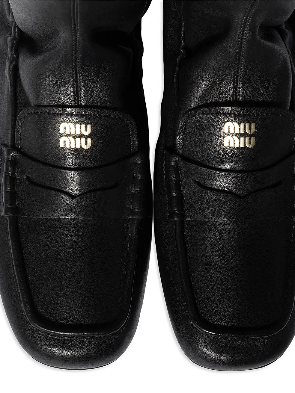 Black Miu Miu leather loafer boots for men, stylish ankle boots with sleek design and polished finish.