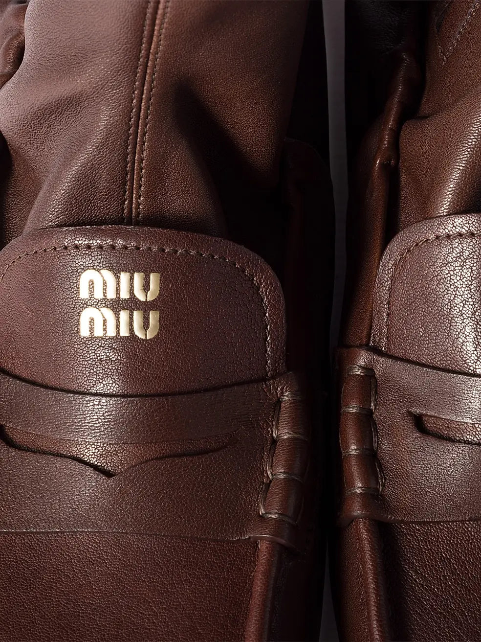 Brown Miu Miu leather loafer boots for men, stylish footwear with sleek design and polished finish.