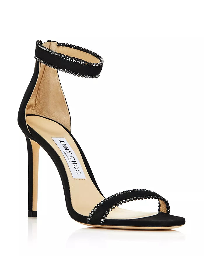 Black suede Jimmy Choo women’s ankle strap heels with crystal embellishments and elegant design.
