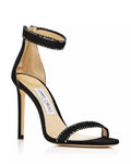 Black suede Jimmy Choo women’s ankle strap heels with crystal embellishments and elegant design.