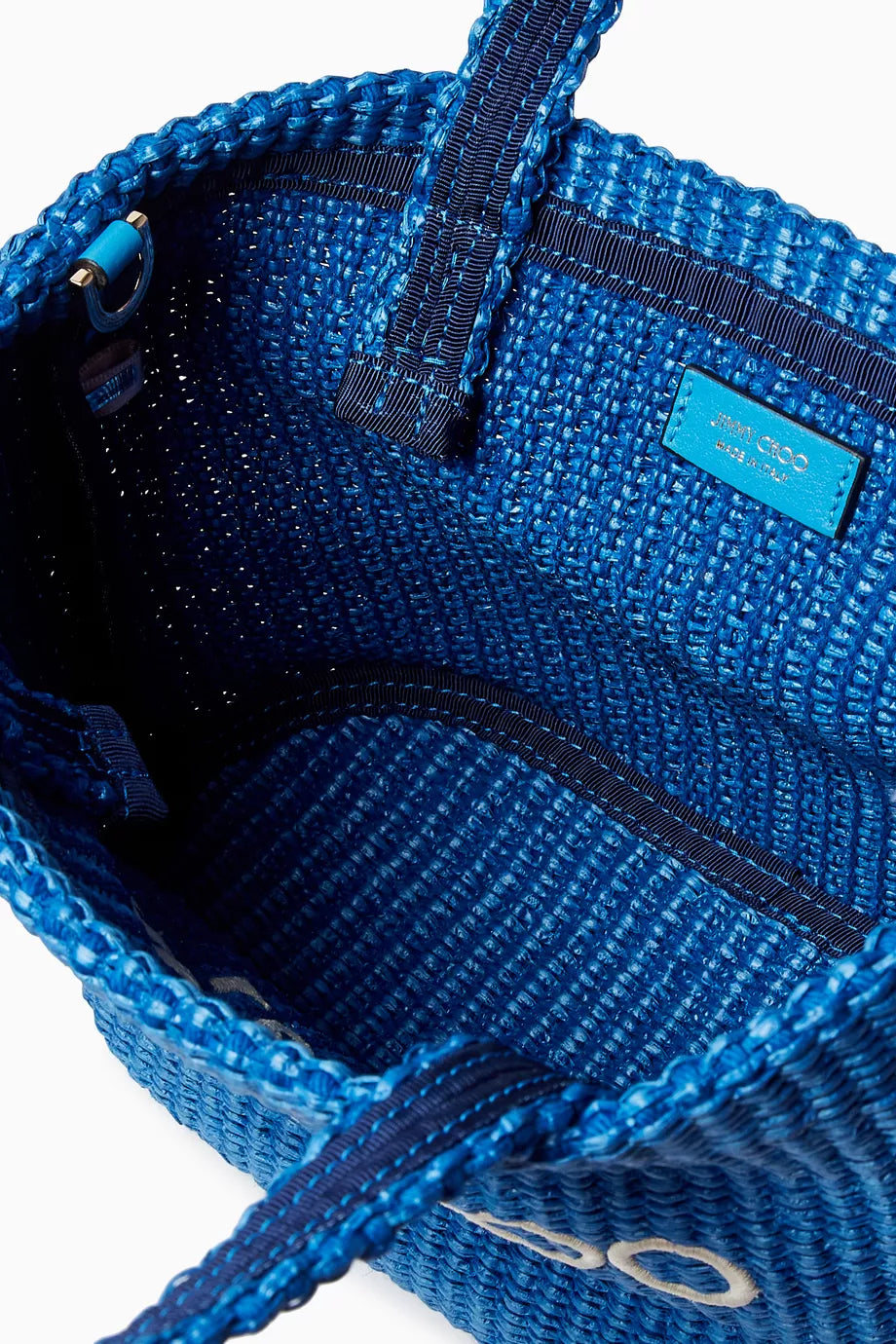 Blue Jimmy Choo mini beach tote bag in raffia with woven texture, ideal for accessories and summer outings.
