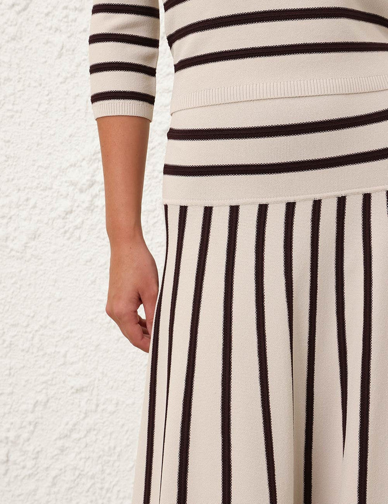 Zimmermann Illuminate Stripe Midi Skirt for women showing the stylish striped design and flowy fabric in a natural pose.
