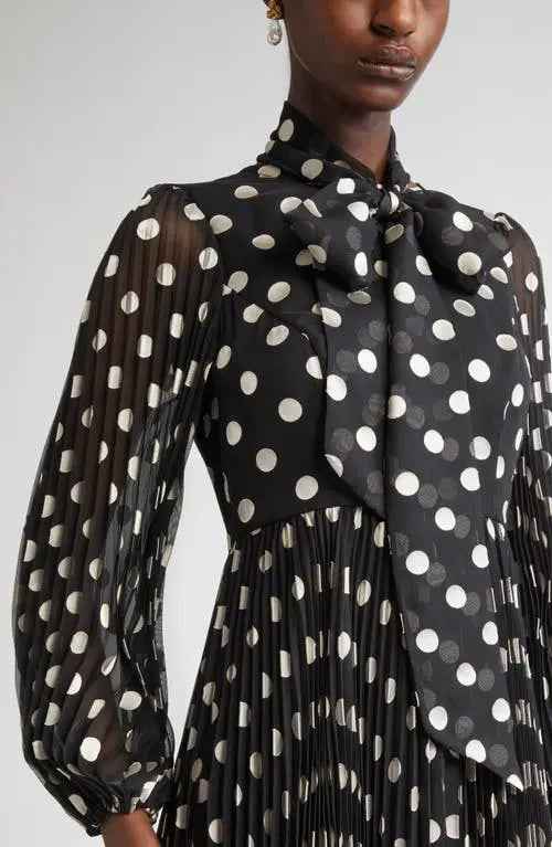 Black and cream polka dot Zimmermann pleated midi dress for women, showcasing a flowy, elegant design with a fitted waist.