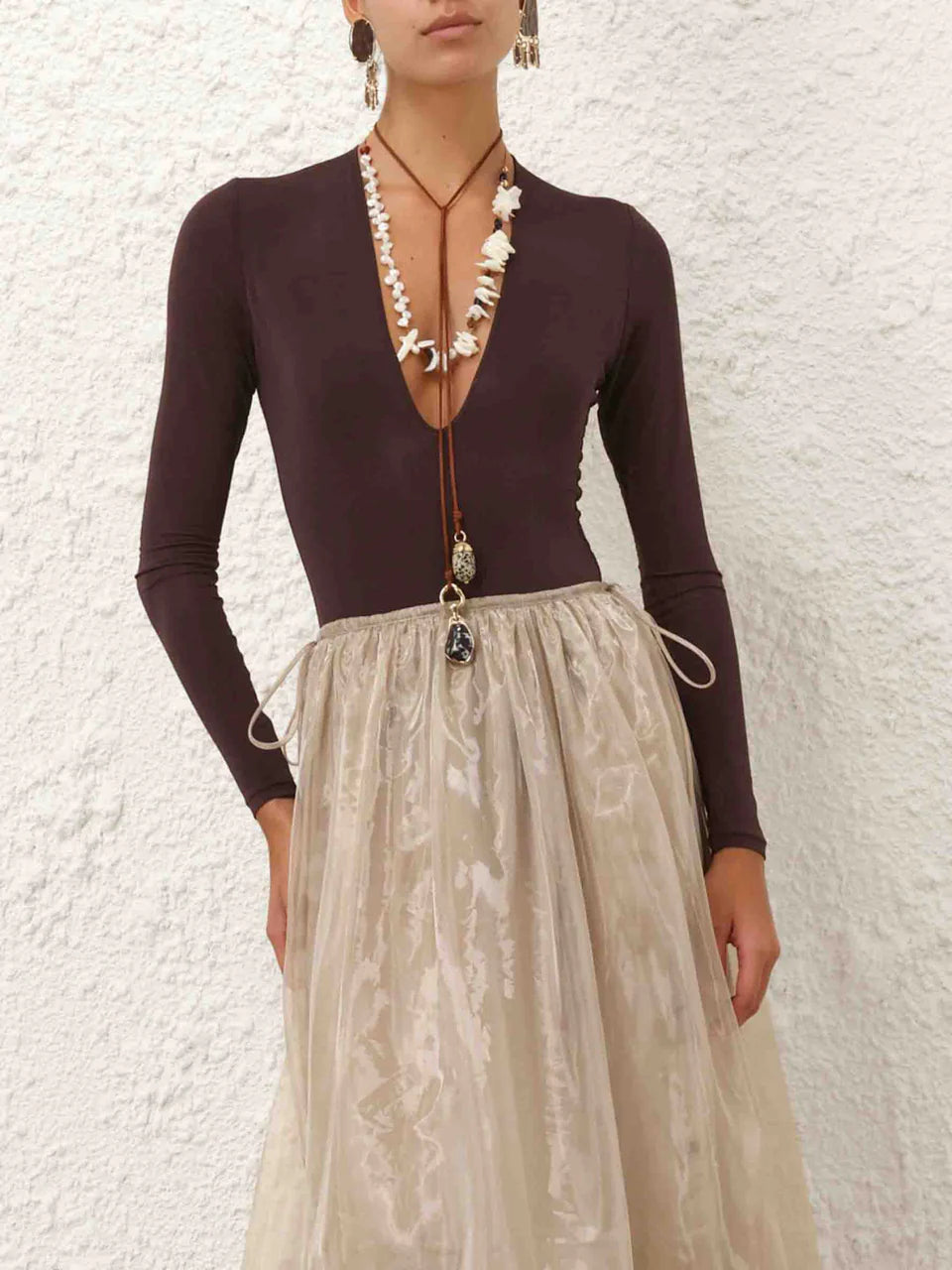 Zimmermann Dawning Sleeve Bodysuit for women, featuring long sleeves and a fitted design, shown in a cropped front view.