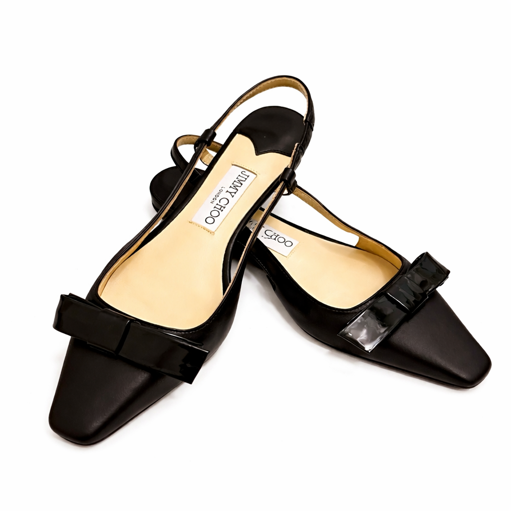 Elegant black Jimmy Choo Amel or Elisa slingback pumps in nappa and patent leather, stylish women’s shoes with pointed toes.