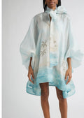 Zimmermann Seascape print long sleeve organza minidress displayed on a model, showcasing the lightweight, flowy fabric and ocean-inspired design.