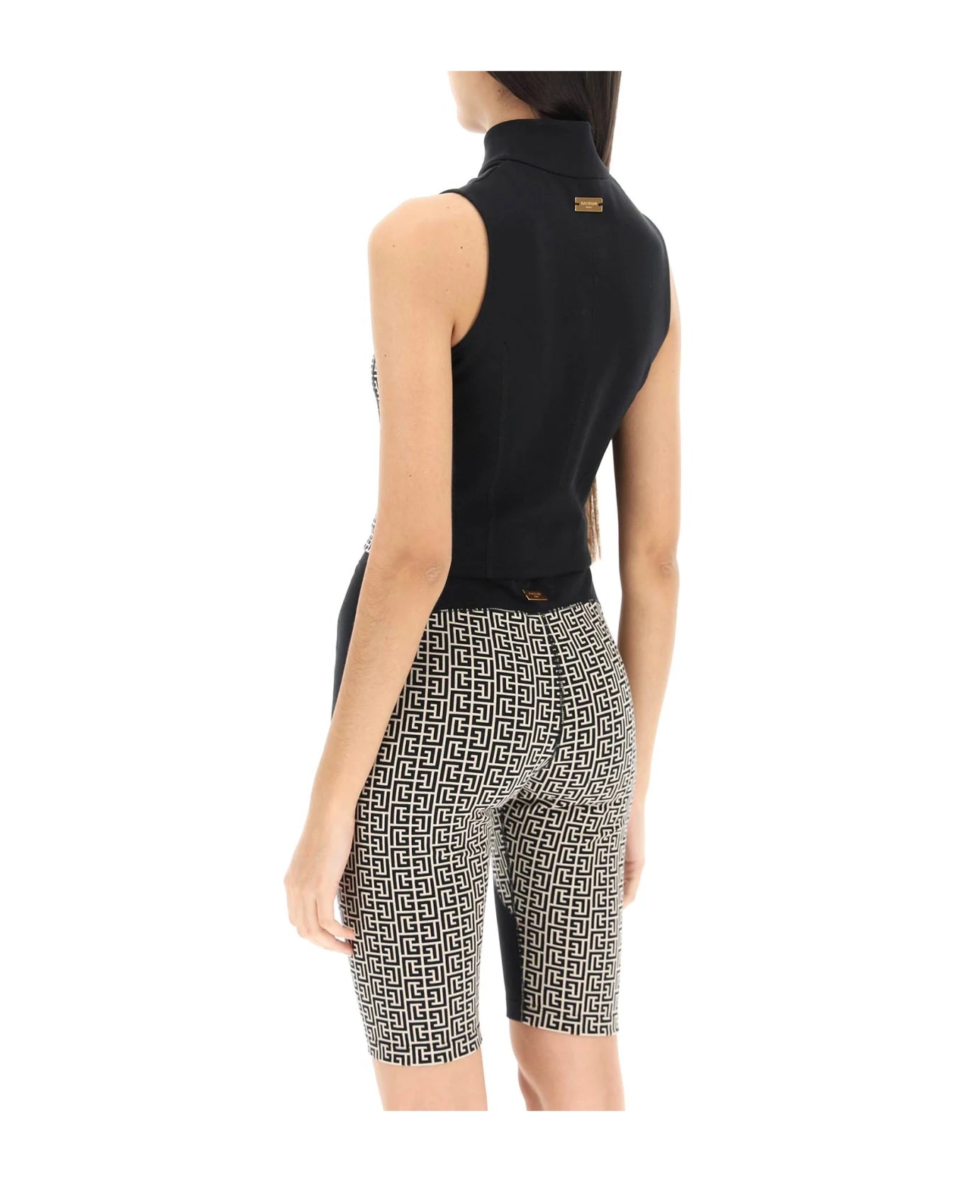 Balmain Monogram Sports Cropped Top for women, featuring bold branding and sporty design, worn by a model showcasing its fit.