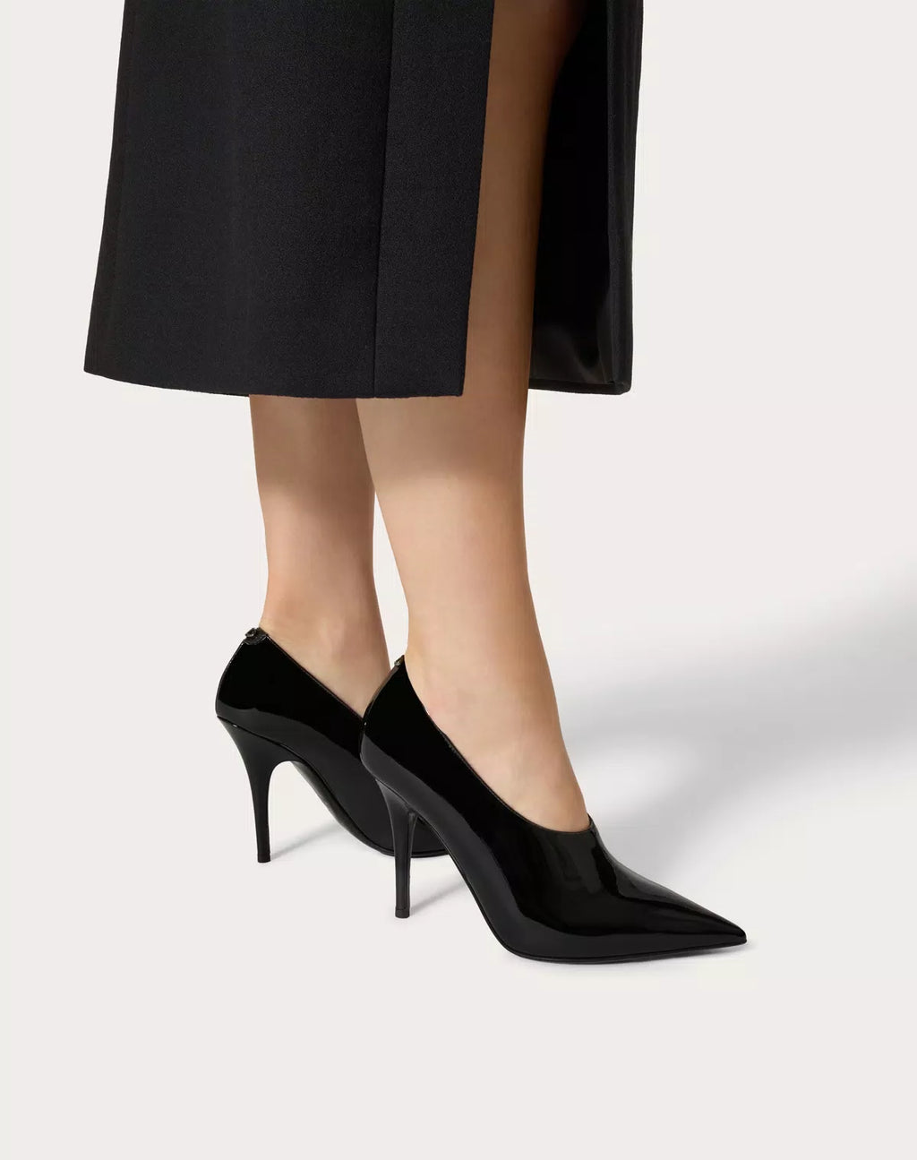 Valentino Garavani Le Salon 105mm patent leather pumps for women, stylish black shoes with pointed toes and sleek design.