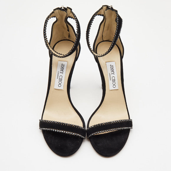 Black suede Jimmy Choo women’s ankle strap heels with crystal embellishments and stiletto heel, stylish and elegant footwear.
