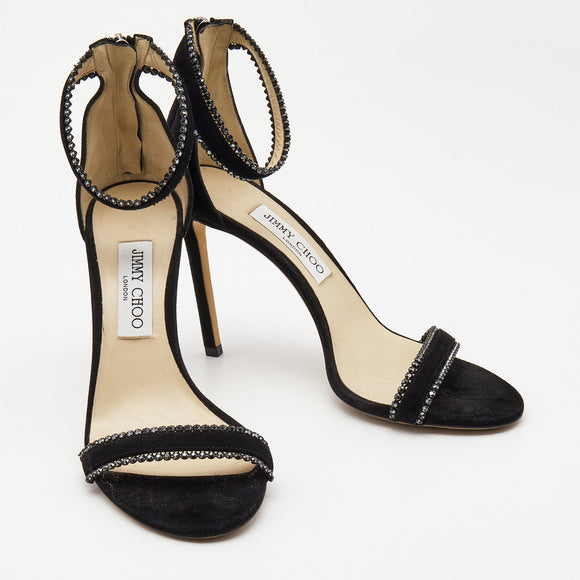 Black suede Jimmy Choo women’s ankle strap heels with crystal embellishments and elegant design.