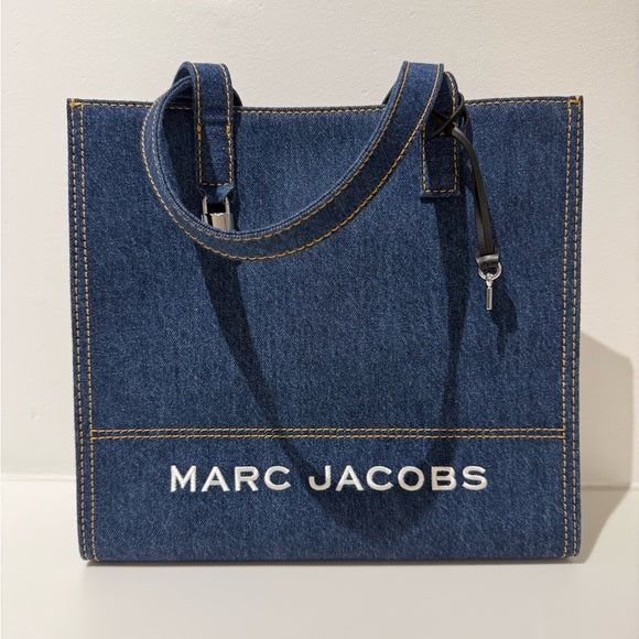 Marc Jacobs denim tote bag with sturdy handles and spacious interior, perfect for casual everyday use.