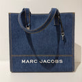 Marc Jacobs denim tote bag with sturdy handles and spacious interior, perfect for casual everyday use.