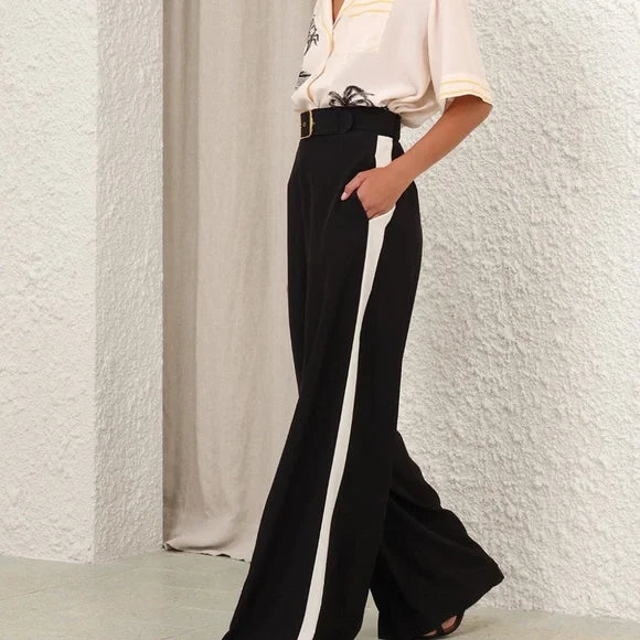 Black Zimmermann track pants for women, featuring a relaxed fit and elastic waistband, shown laid flat on a white background.