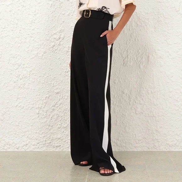 Black Zimmermann Track Pant for women, featuring a relaxed fit and sporty style, shown on a model in a casual setting.