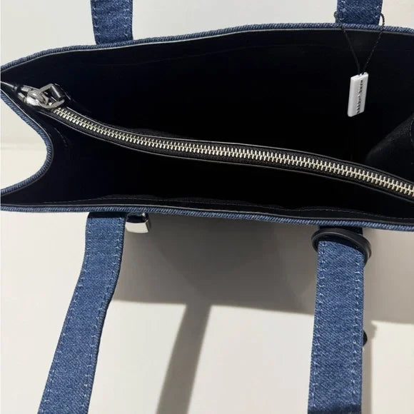 Marc Jacobs denim tote bag with sturdy handles and spacious interior, perfect for casual everyday use.