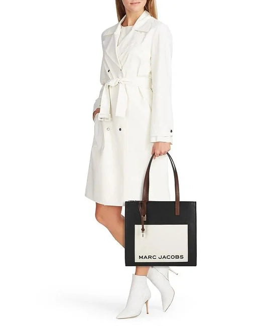 Black leather tote bag with multicolor Grind logo from Marc Jacobs, featuring sturdy handles and spacious interior.