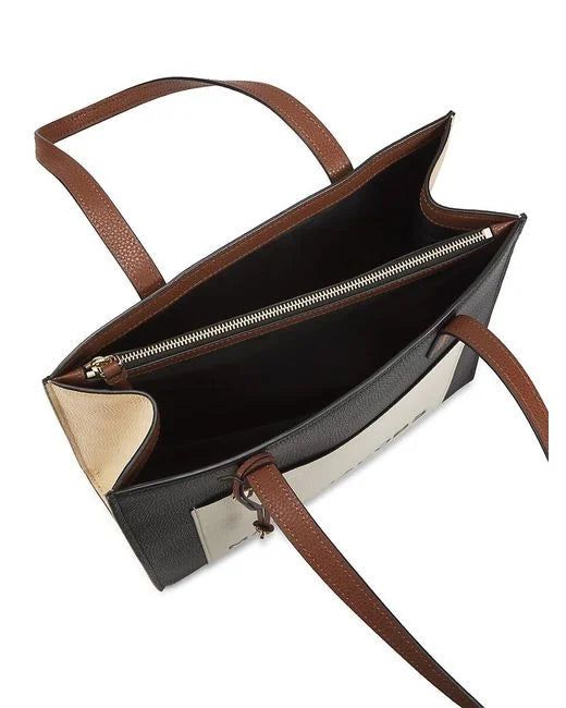 Black leather tote bag with multi-color Grind logo and sturdy leather handles, designed by Marc Jacobs.