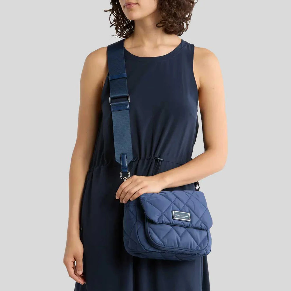 Marc Jacobs women's quilted nylon crossbody bag with adjustable strap and sleek design, shown in black fabric.