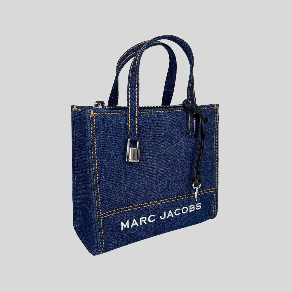 Marc Jacobs denim tote bag with leather handles and spacious interior, stylish and durable for everyday use