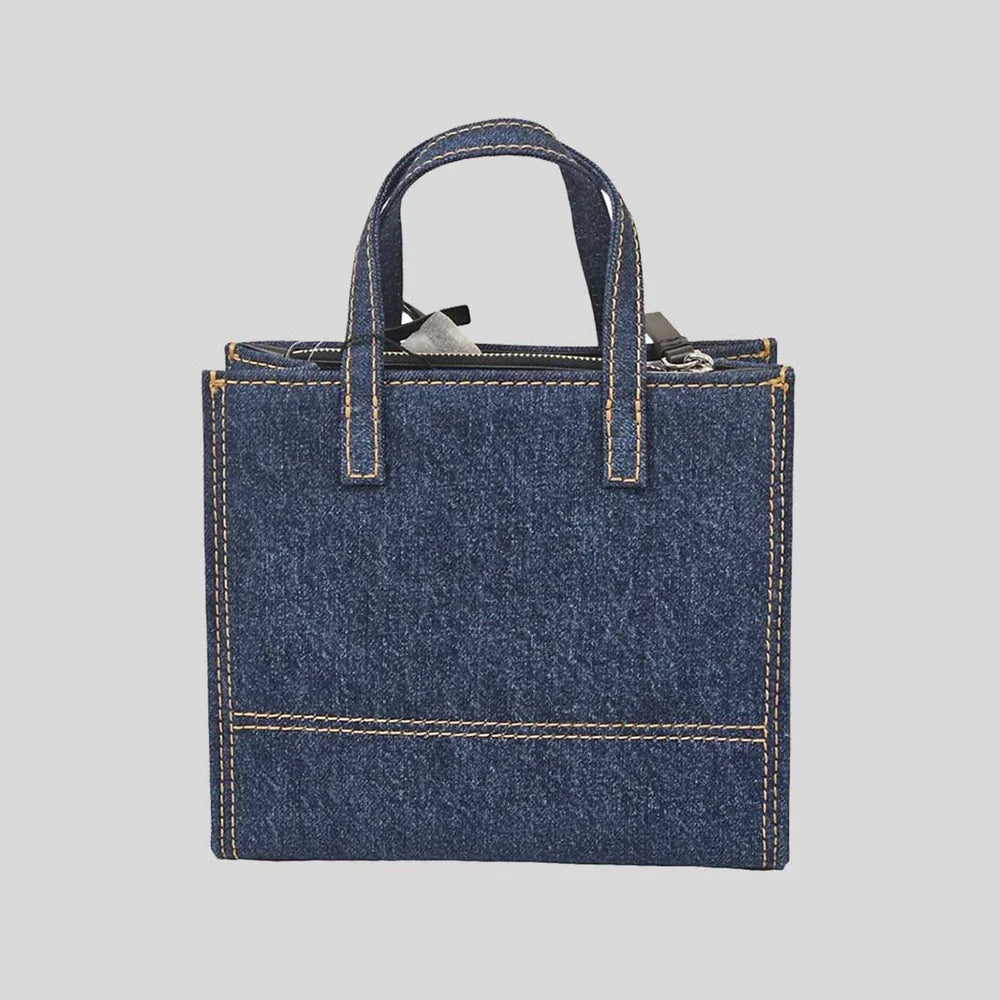 Marc Jacobs denim tote bag with logo print, sturdy handles, and spacious interior, perfect for everyday use and casual style.