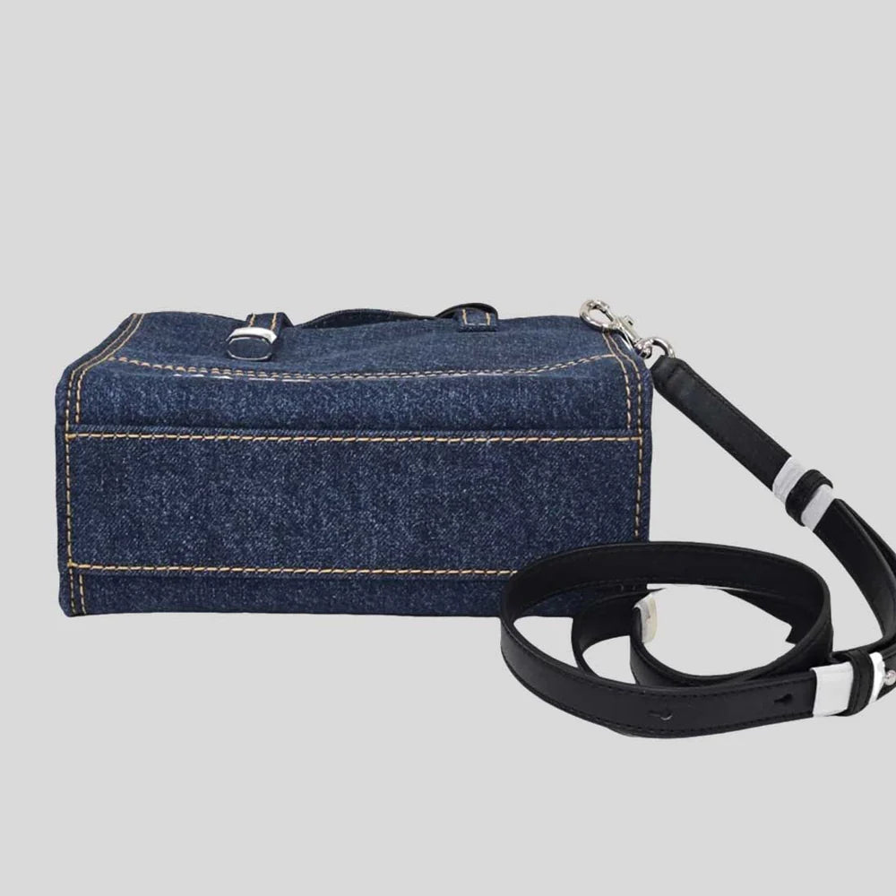Blue denim tote bag by Marc Jacobs with sturdy handles and minimalist design, perfect for everyday use.
